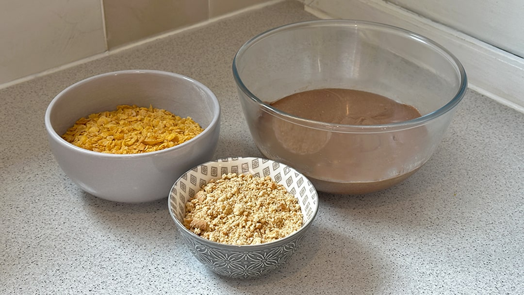Add crushed cornflakes and digestives to chocolately mixture
