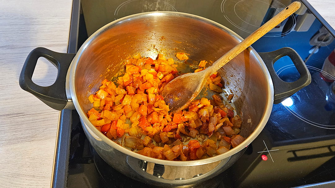 Add garlic, ginger, tomato puree and spices to the onion and pepper