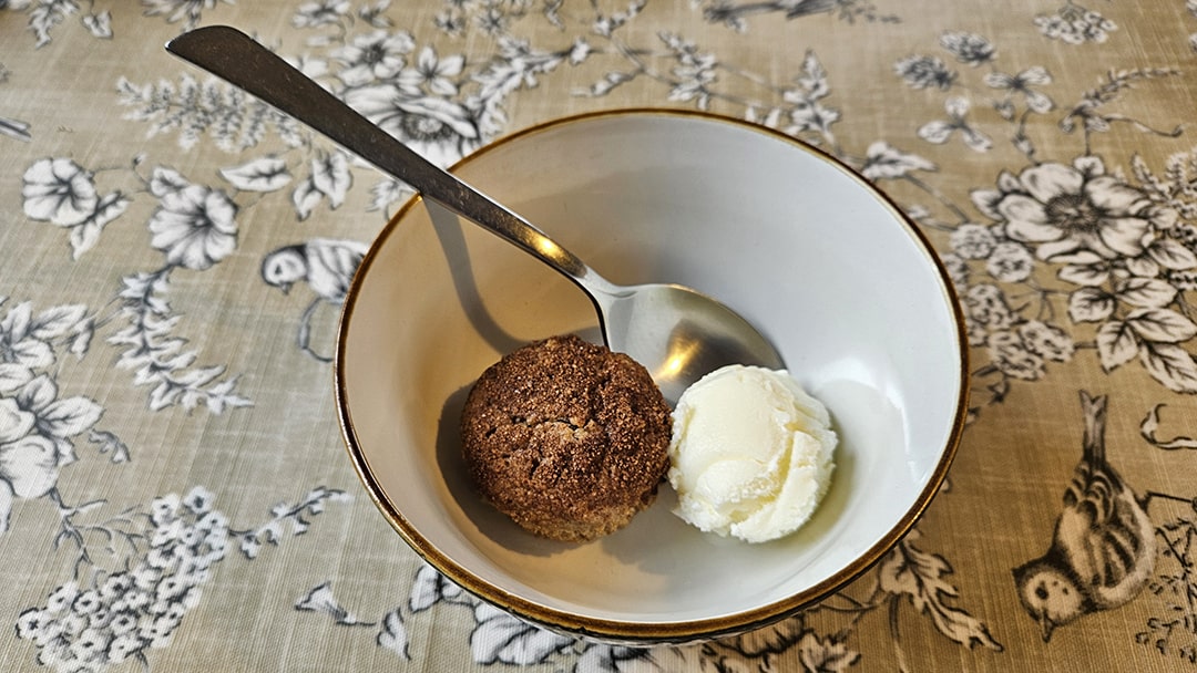 Apple and cinnamon muffin served with a scoop of ice cream