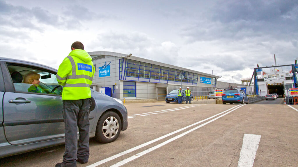 Security collect boarding passes before passengers drive on board