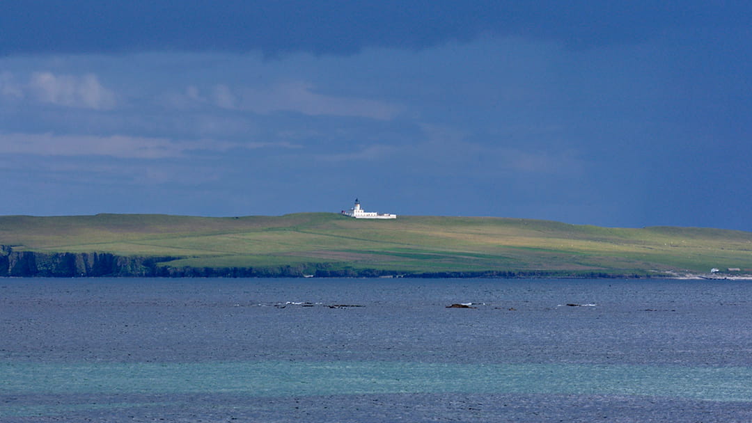 Copinsay Lighthouse viewed from Deerness in Orkney