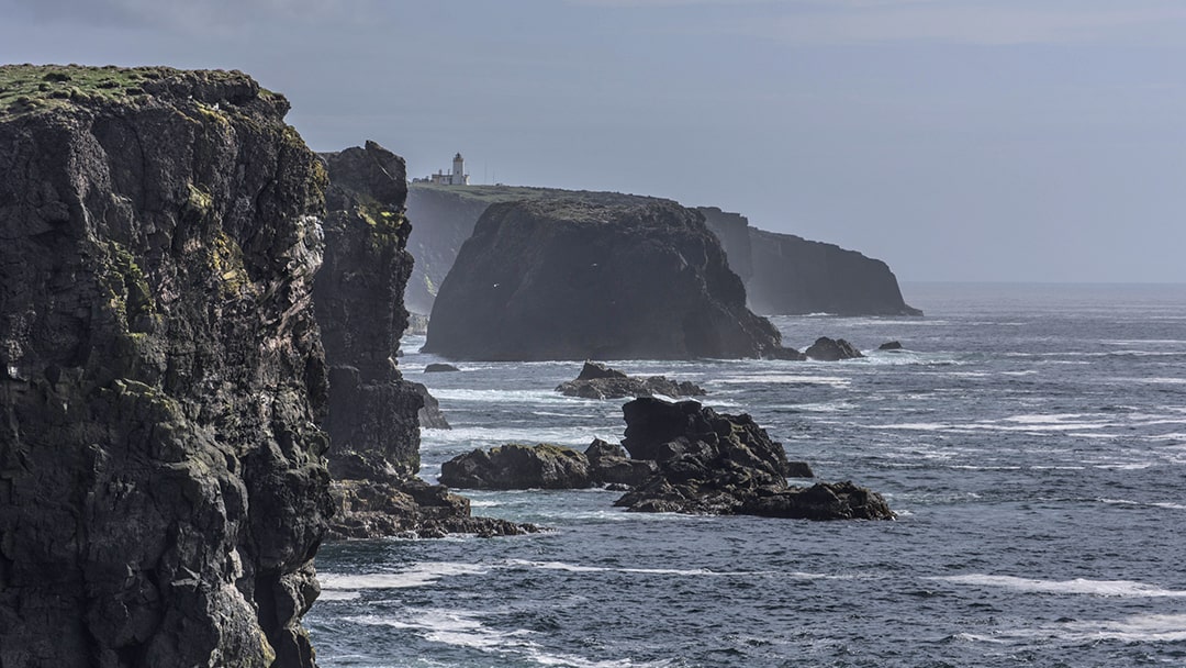 Eshaness Lighthouse sits on top of 200-foot cliffs