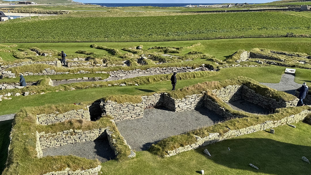 Looking towards walls of the Laird's House with Norse settlements to the rear at Jarlshof, Shetland