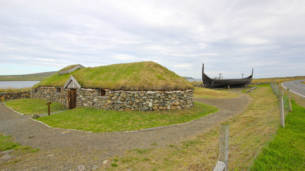 Viking places in Shetland - the Skidbladner replica Viking longship and a replica Viking longhouse at Haroldswick in Unst